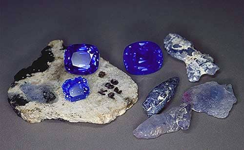 Rough and cut Kashmir sapphires. The cut stones range from 6–14 ct. Photo: Henry Hänni/SSEF
