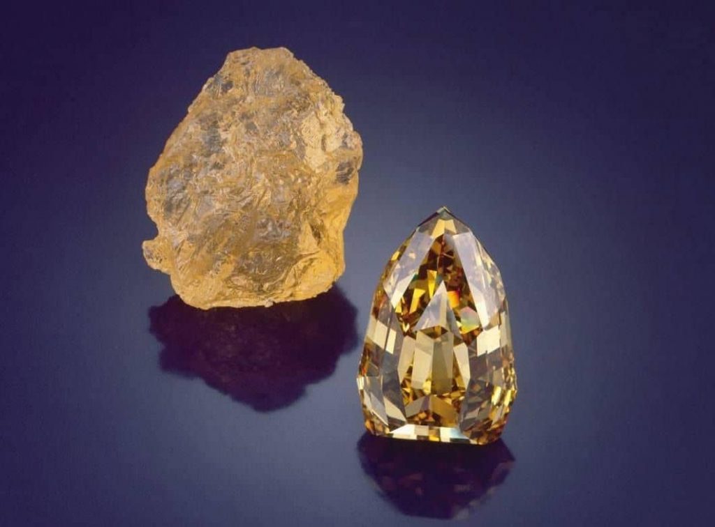 890 carat rough diamond found in the early-1980s in Mbuji Mayi, Democratic Republic of Congo.
407.48 carat Fancy brownish yellow Diamond, shield-shape, internally flawless.